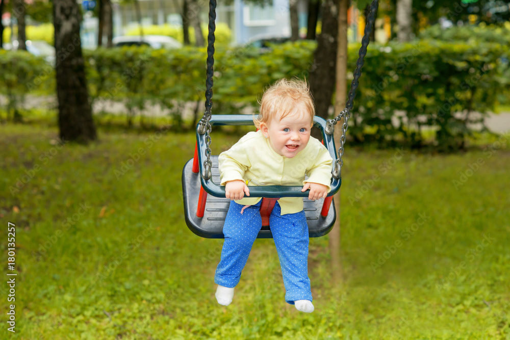 A cute baby child having fun on a swing A cute baby child having fun on a swing