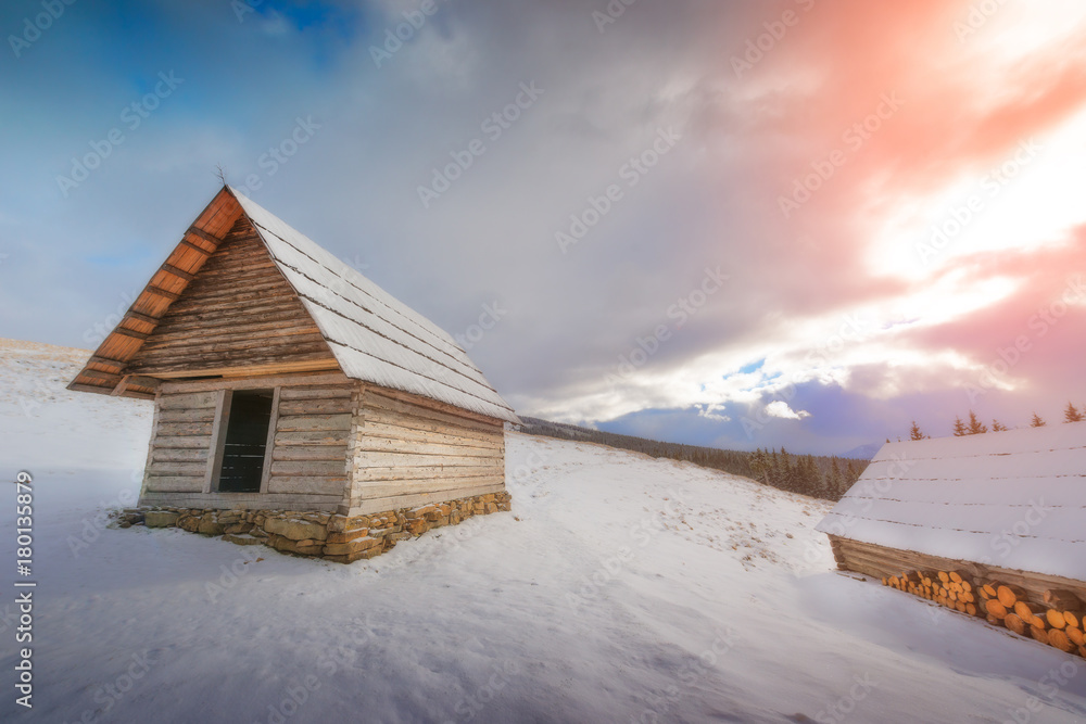 Dramatic view of a wooden house in winter Dramatic view of a wooden house in winter