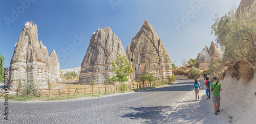 Group of Friends travelling among Cappadocia fairy chimneys at summer