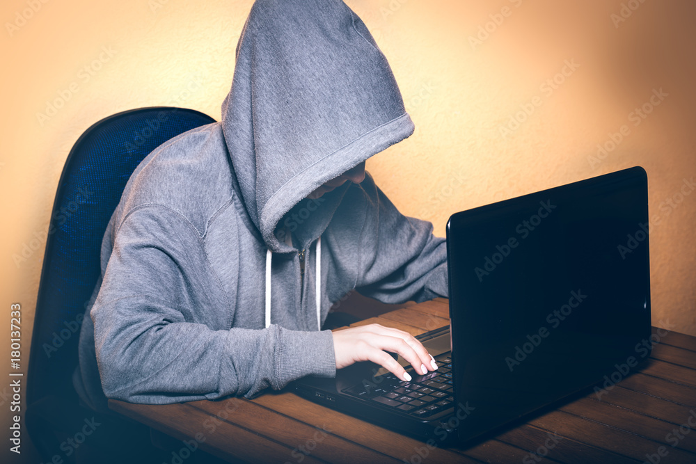 A hacker working on a laptop A hacker working on a laptop