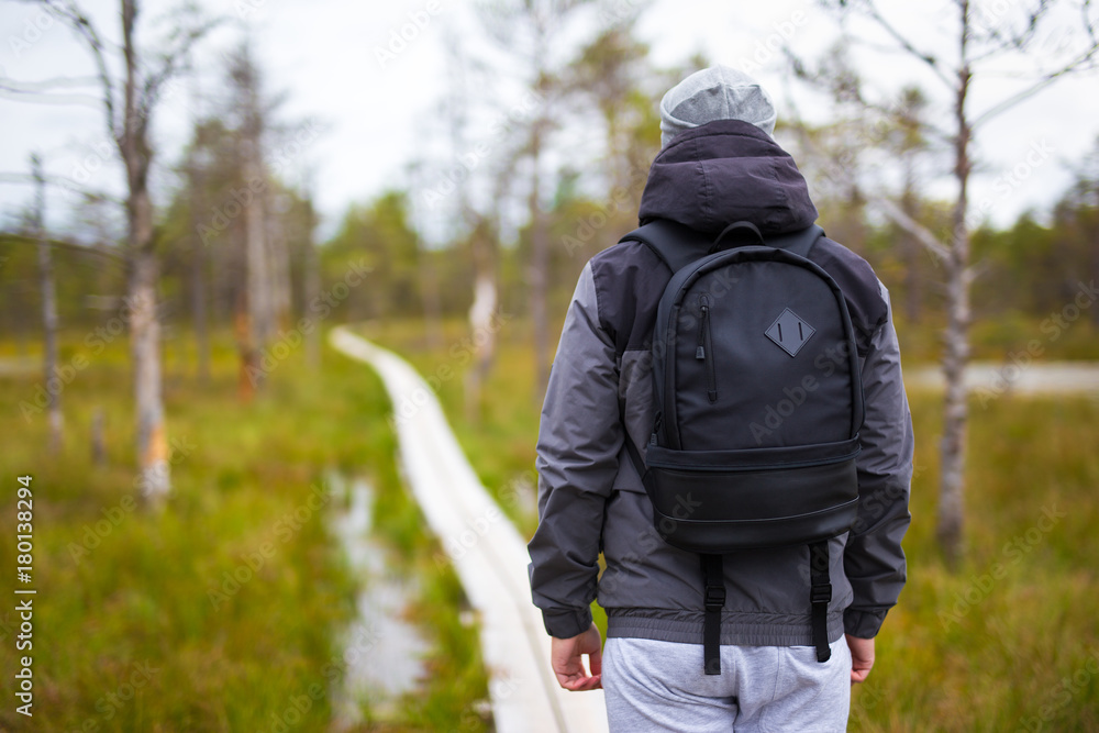 rear view of man hiking in forest