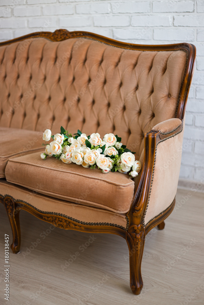 rose flowers on beige vintage sofa Stock Photo | Adobe Stock
