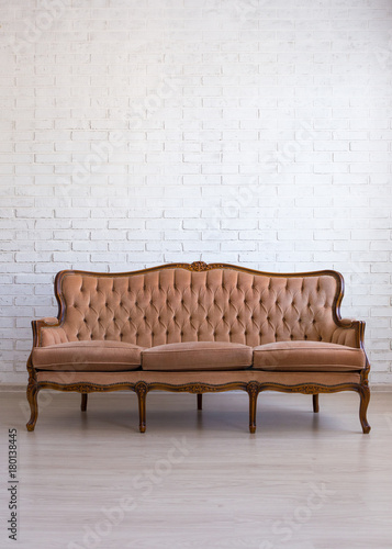 vintage sofa over white brick wall