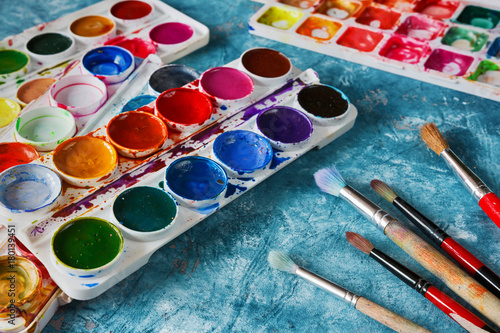 Gouache paints and art brushes for the artist with a copy space