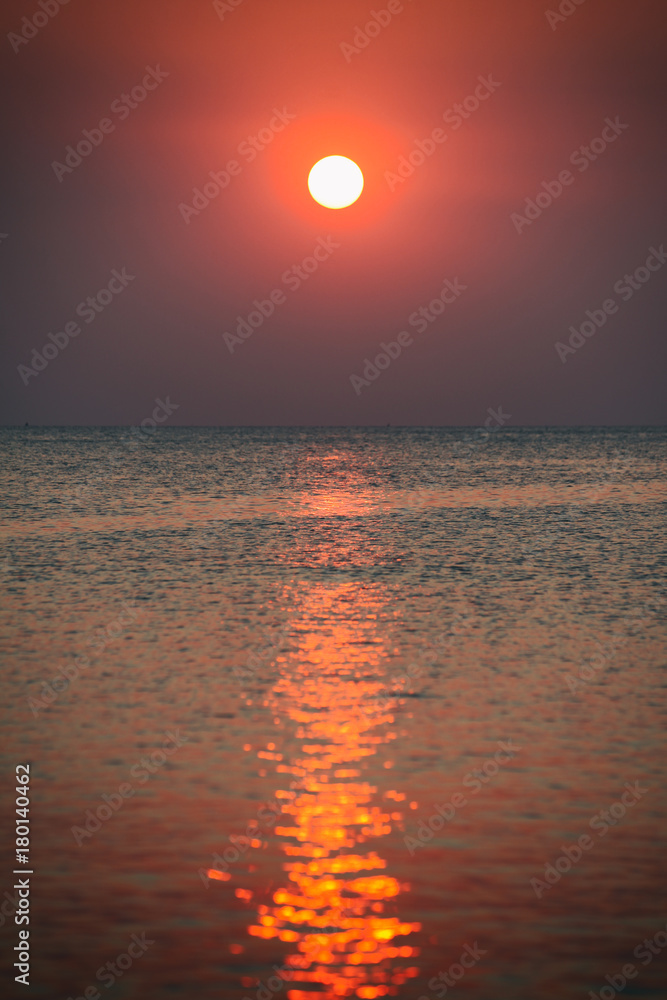 Sunset at the beach of Phu Quoc, sun disk beam
