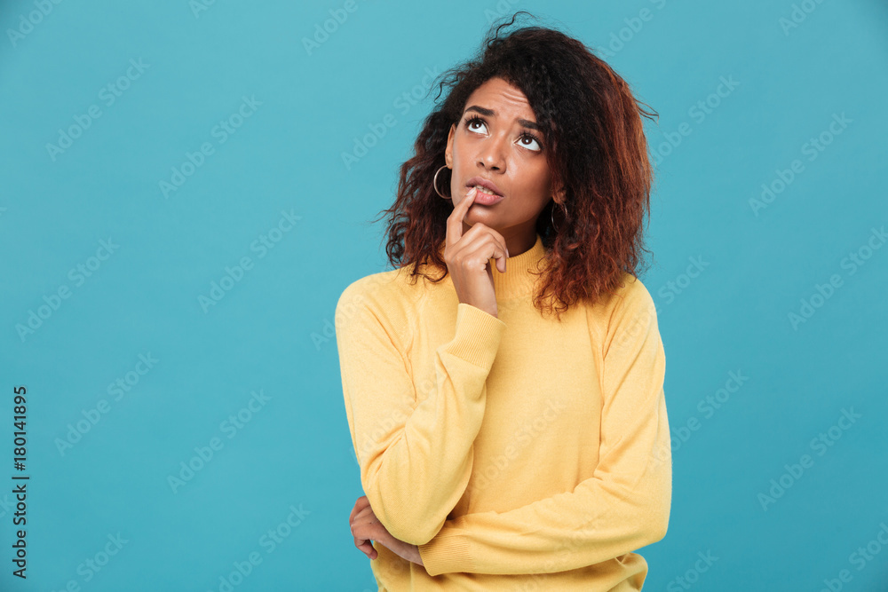 Thinking young african lady dressed in warm sweater Thinking young african lady dressed in warm sweater