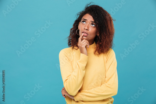 Thinking young african lady dressed in warm sweater © Drobot Dean