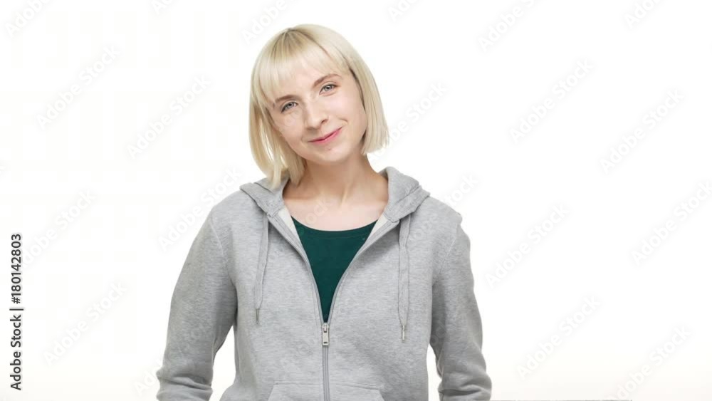 Closeup portrait of cute blond woman with bob haircut in sweatshirt looking at camera smiling being optimistic isolated over white background. Concept of emotions Closeup portrait of cute blond woman with bob haircut in sweatshirt looking at camera smiling being optimistic isolated over white background. Concept of emotions