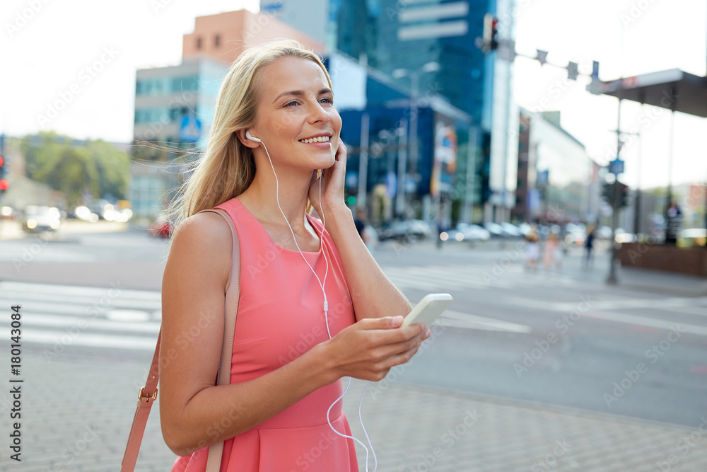 happy young woman with smartphone and earphones