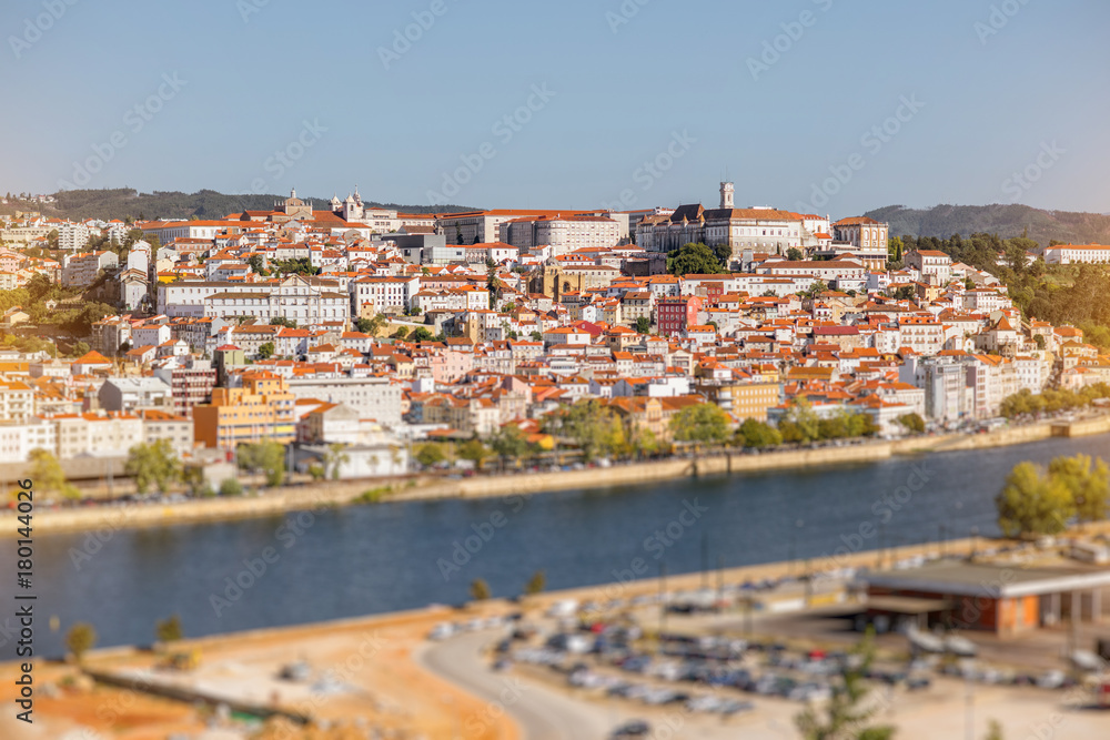 Cityscape view on the old town of Coimbra city with Mondego river during the sunny day in the central Portugal