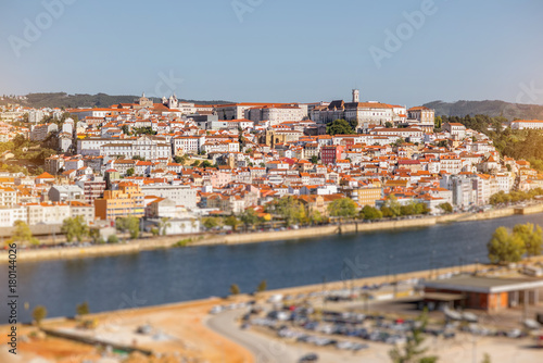 Cityscape view on the old town of Coimbra city with Mondego river during the sunny day in the central Portugal