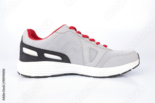 Gray sneakers with red laces on a white background