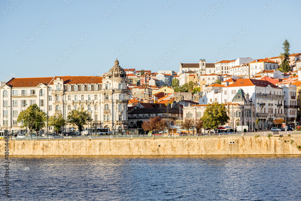 Cityscape view on the old town of Coimbra city with Mondego river during the sunset in the central Portugal