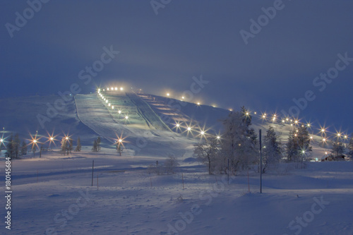 Downhill ski slope in the evening lighting