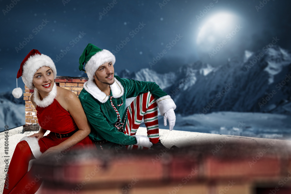 Obraz premium Christmas elf. Roof with chimney. Mountain view with snow and moon. December night. Christmas Eve.