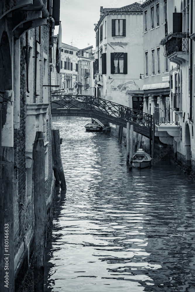 Fototapeta premium Canal in Venice, Italy. Venice cityscape, narrow water canal and traditional buildings. Italy, Europe. Italy beauty, silence on typical canal street in Venice, Venezia. Black and White photo.