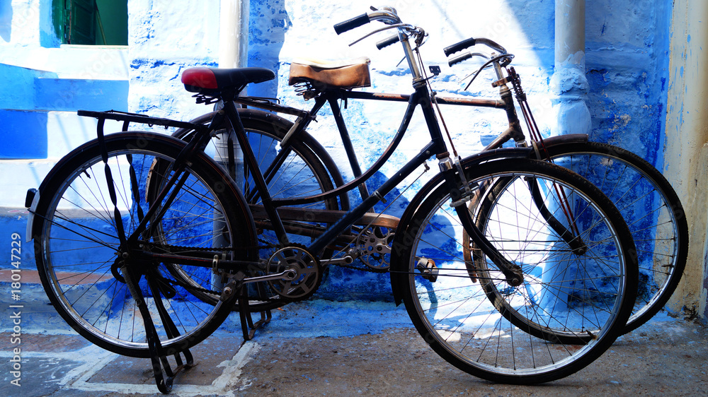 Blue city, Jodhpur, Rajasthan, India. Blue house background. Blueand wall. Popular tourist city - holidays in India. Old vintage bicycle near the blue wall.