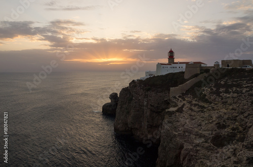 View of the lighthouse and cliffs at Cape St. Vincent at sunset. Sagres, Algarve, Portugal.