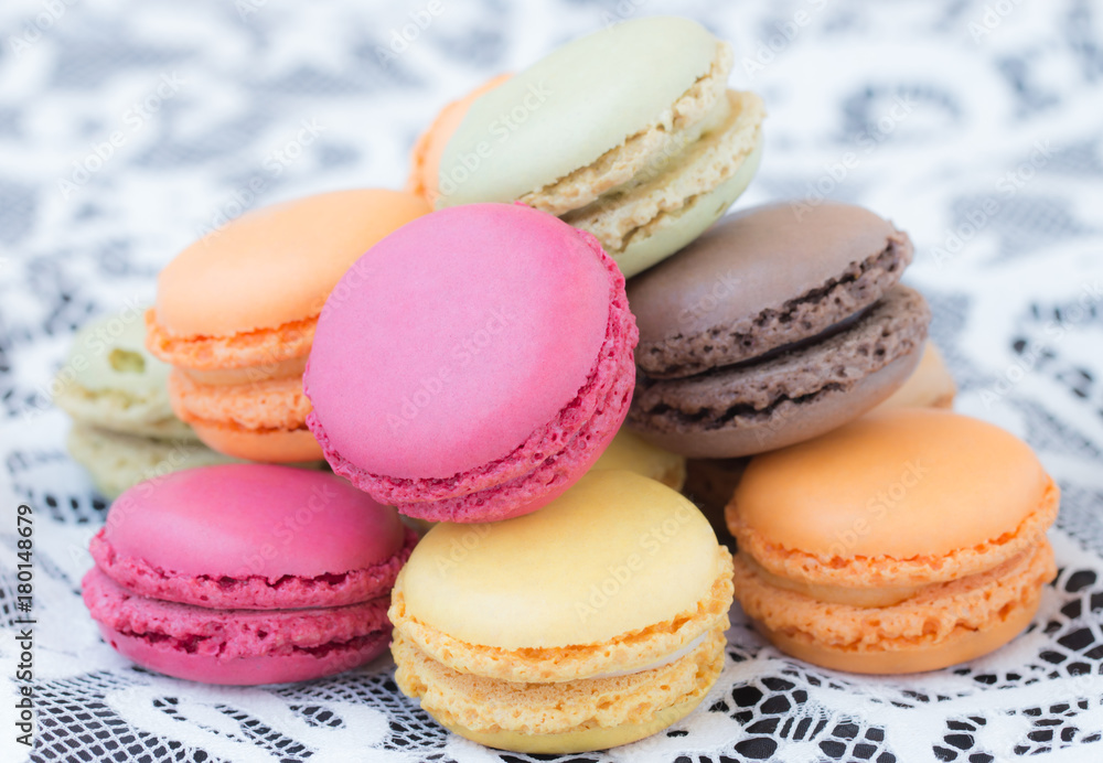 Colorful macaroons on a white lace background. Colorful macaroons on a white lace background.