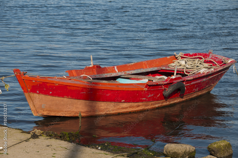 red boat moored in the port of Combarro