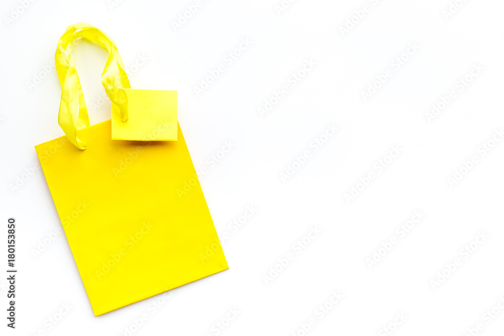 Yellow bright shopping bag on white background top view copyspace Yellow bright shopping bag on white background top view copyspace