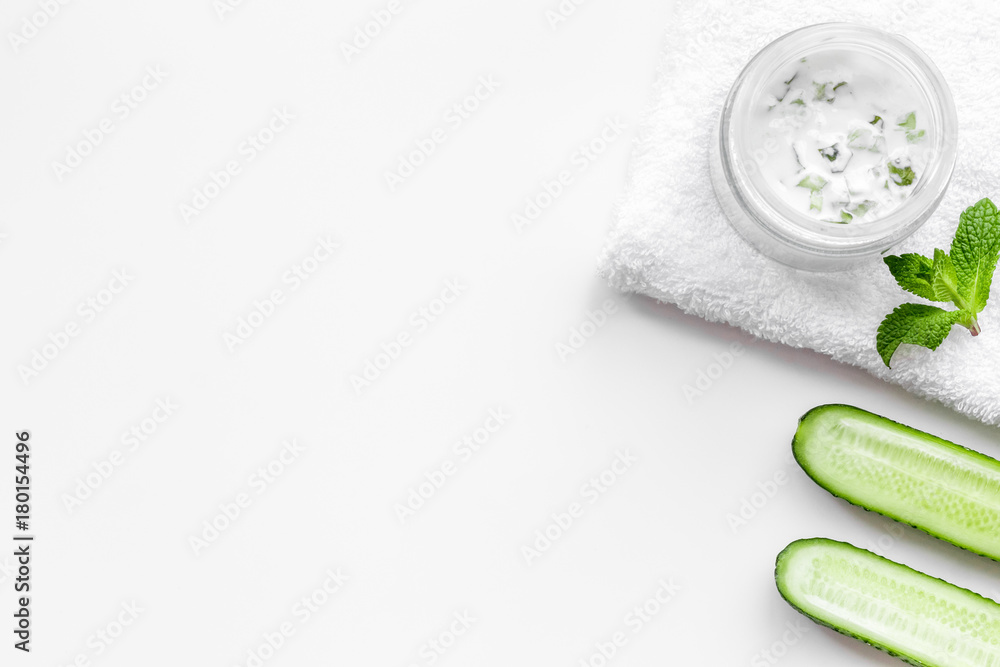 Cucumber moisturising cream or mask. White background top view copyspace