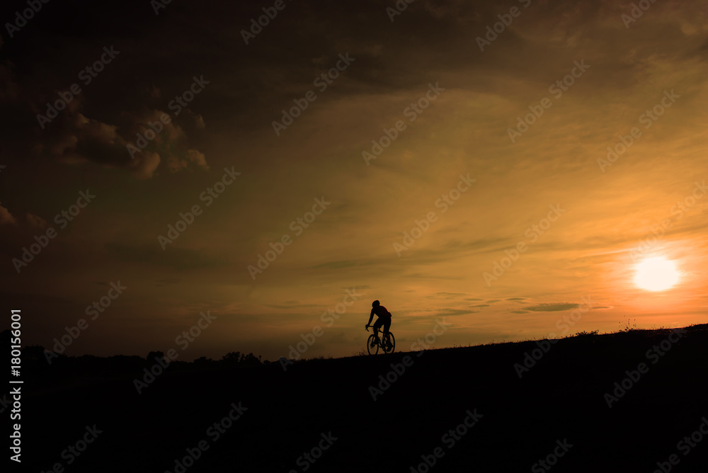 Silhouette of handsome man riding bicycle on sunset,sport man concept,Fill flare effect