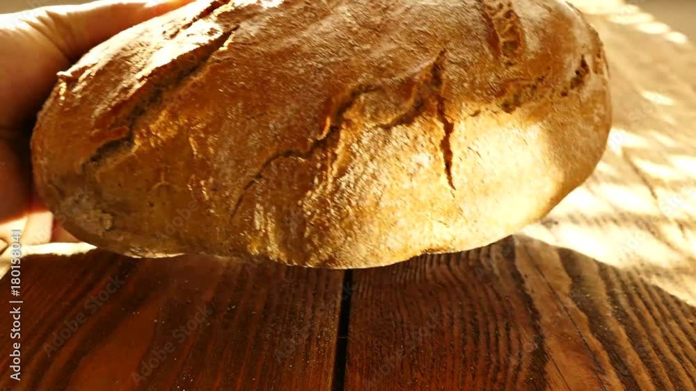 Fresh bread on the table. Bread in the hands.