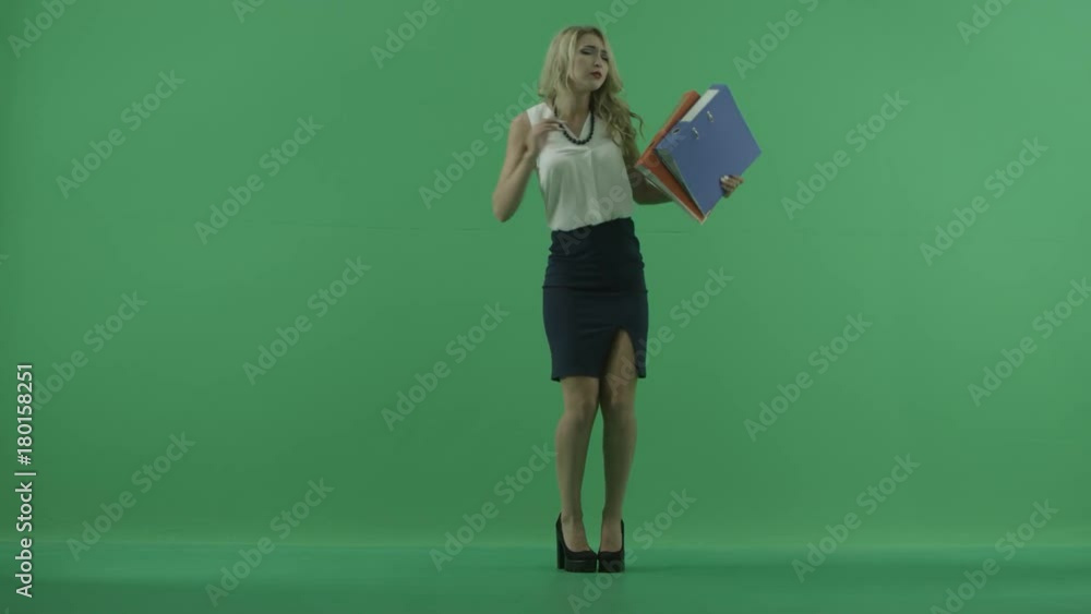 Young woman dancing with folders in full body shot over chroma key Young woman dancing with folders in full body shot over chroma key