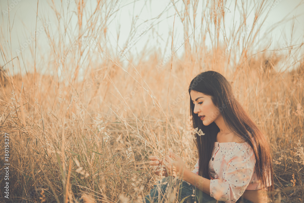 Close up of lonely woman alone in a field. Vintage filter style.Disappointed by love.Heartbroken from a lover.heartbreak girl concept Close up of lonely woman alone in a field. Vintage filter style.Disappointed by love.Heartbroken from a lover.heartbreak girl concept