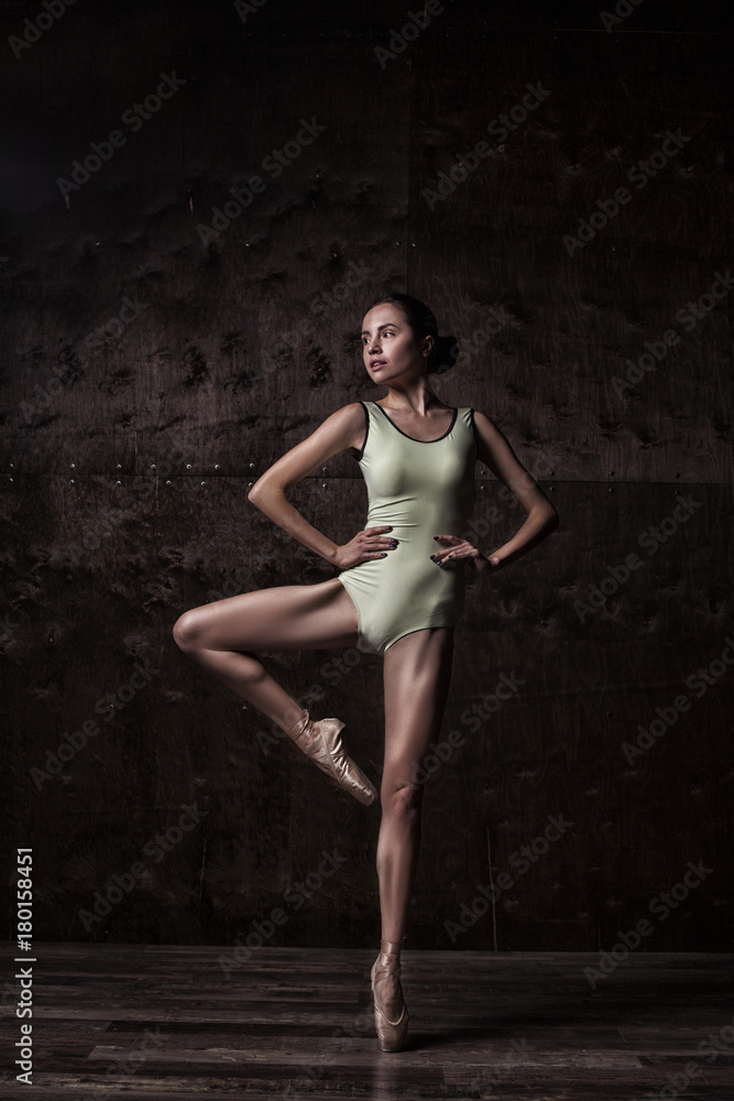 young beautiful ballet dancer in green swimsuit posing on pointes young beautiful ballet dancer in green swimsuit posing on pointes