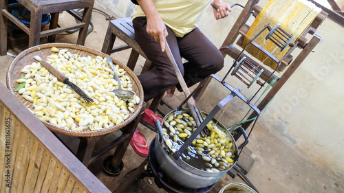 Weaver is boiling cocoons and spin thread to make silk
