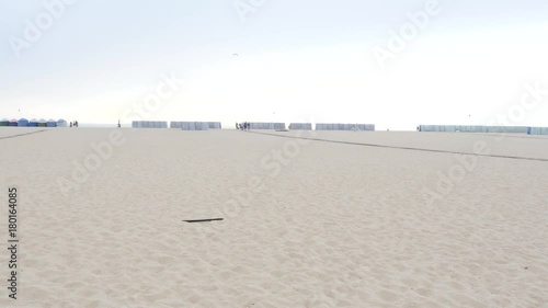 Empty white sand beach with tents