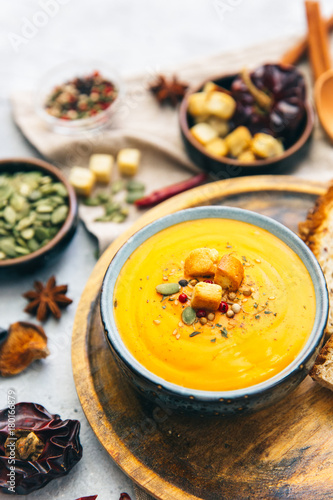 Bowl with pumpkin soup and spices.