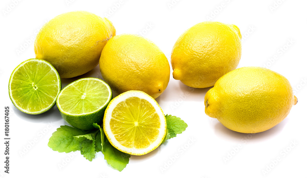 Two whole lemons, lime and lemon halves with fresh lemon balm leaves isolated on white background.