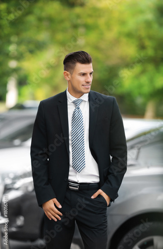 Attractive man in formal suit on city street © Africa Studio
