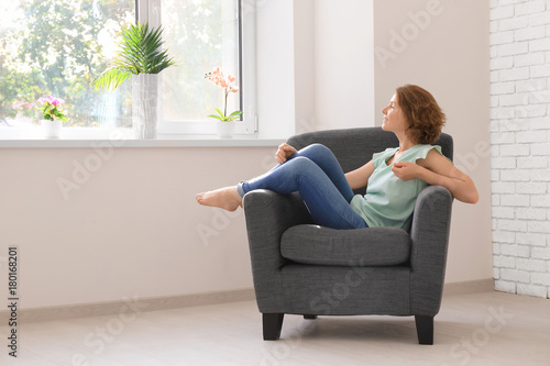 Young woman resting in armc...
