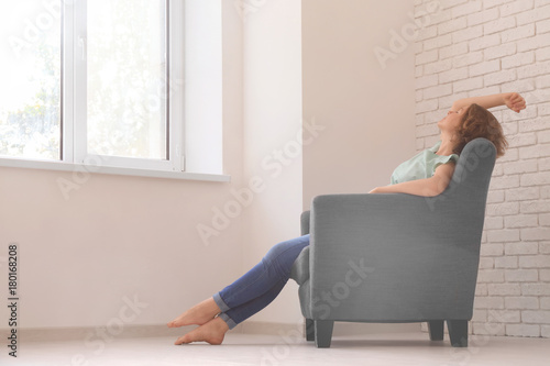 Young woman resting in armc...