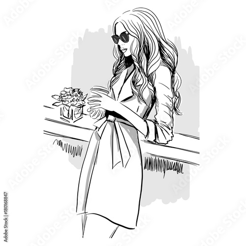 woman in trench coat with coffee
