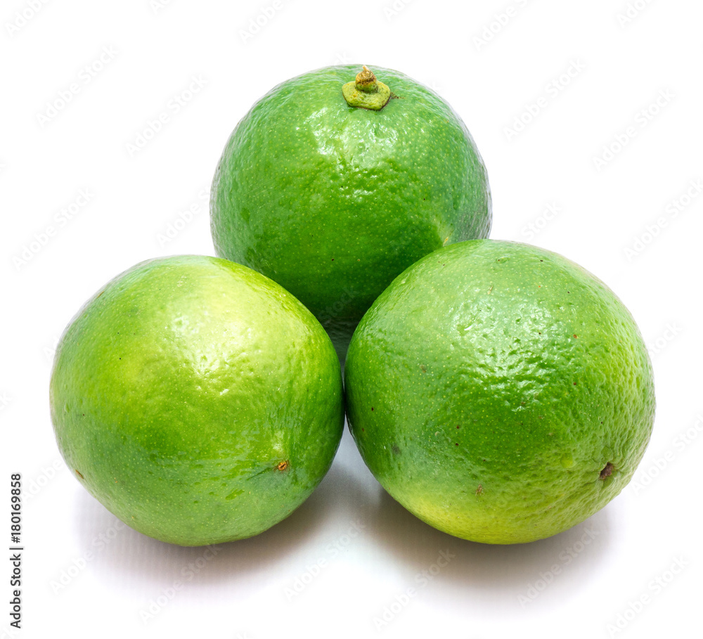Three whole green limes isolated on white background. Three whole green limes isolated on white background.