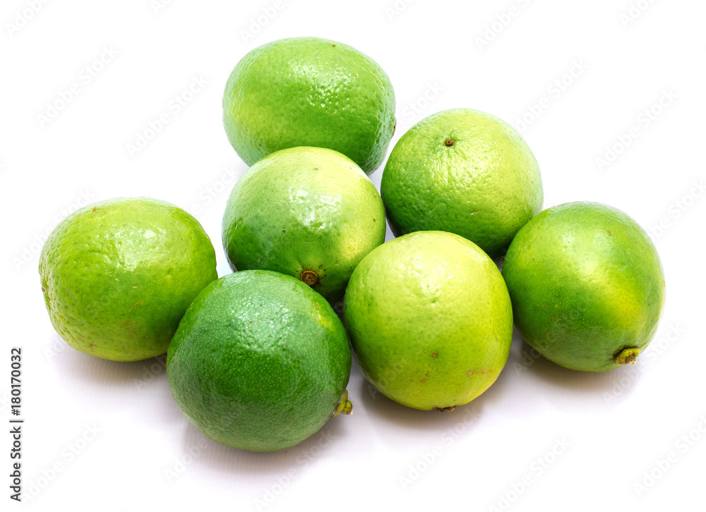 Group of whole green limes isolated on white background. Group of whole green limes isolated on white background.