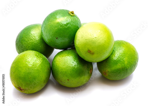 Group of whole green limes isolated on white background.