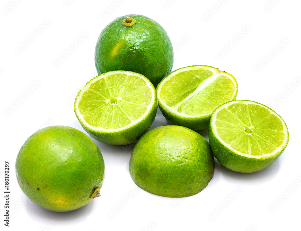 Group of whole and lime halves isolated on white studio background.