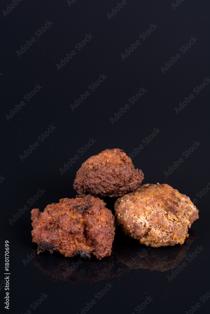Meatballs isolated above black background with reflections and copy space Meatballs isolated above black background with reflections and copy space