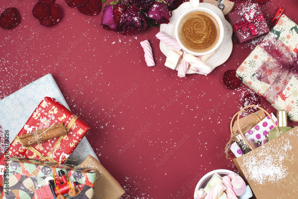 Christmas gifts in bright boxes on a red background and coffee with marshmallows Christmas gifts in bright boxes on a red background and coffee with marshmallows
