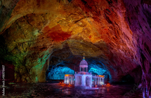 Cave with ice floor. The cave is illuminated. Karelia. Russia. Tourism in Russia. The town of Ruskeala. photo