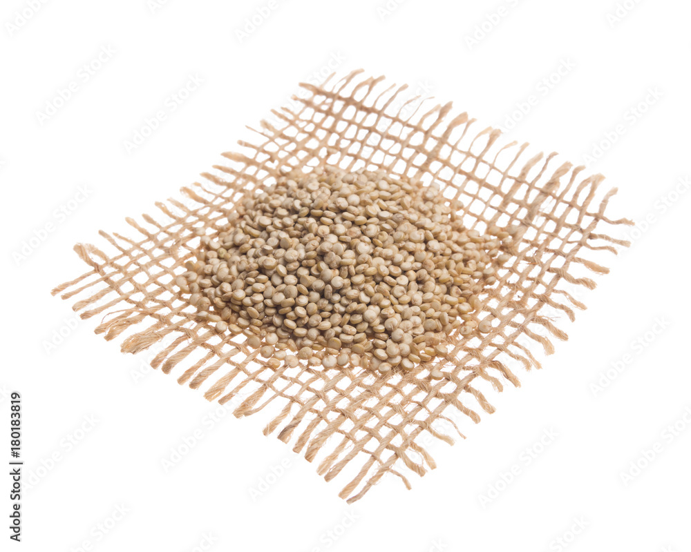 Golden Quinoa. Grains over hessian fabric, isolated white background. Golden Quinoa. Grains over hessian fabric, isolated white background.
