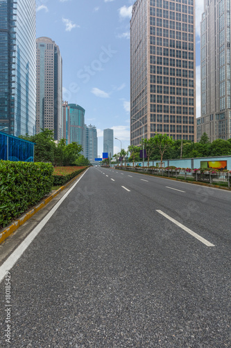 empty asphalt road front of modern buildings. © hallojulie