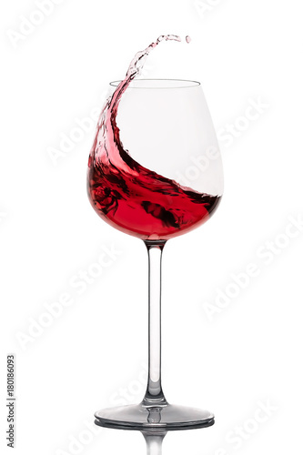 moving red wine glass over a white background