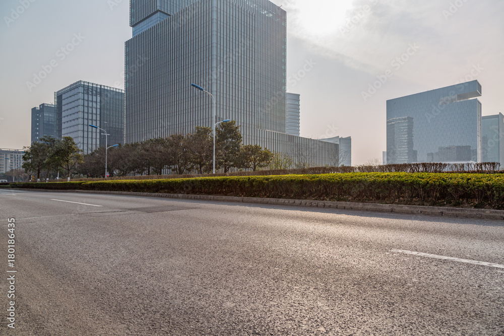 empty asphalt road front of modern buildings. empty asphalt road front of modern buildings.